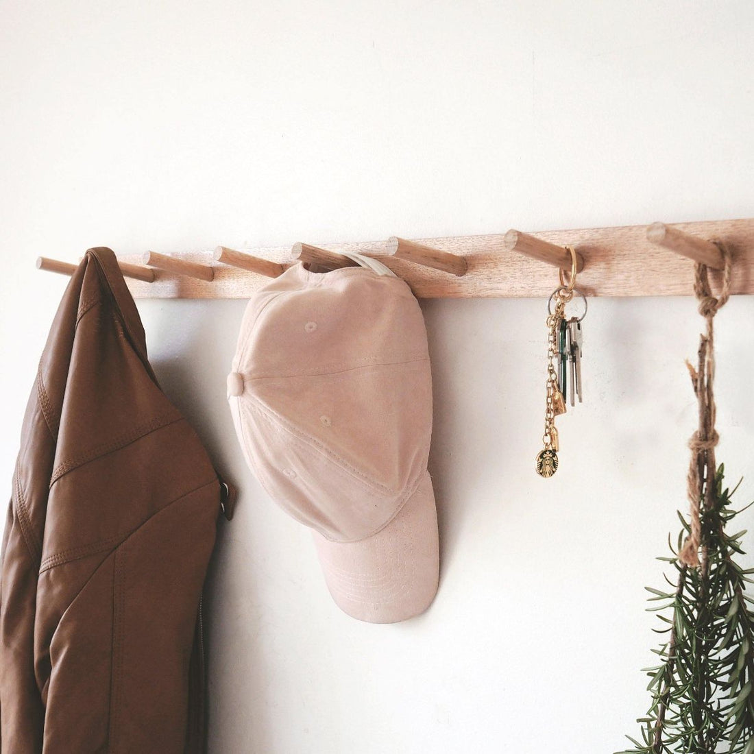 peg rail with jacket, cap and keys hanging