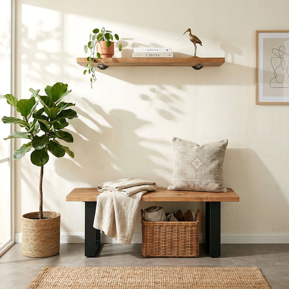 Nest living room with wooden bench, plant, shelf, and decor items.
