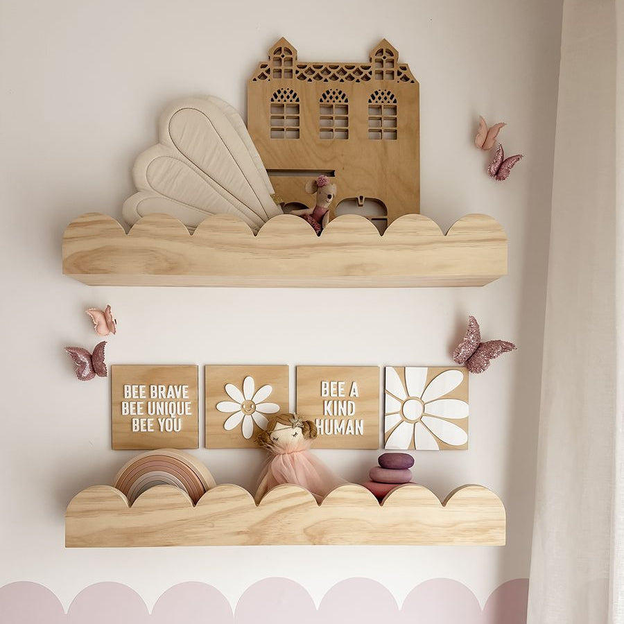 This is a wooden scallop style wall shelf for the kids bedroom. Perfect nursery decoration. Front view photo