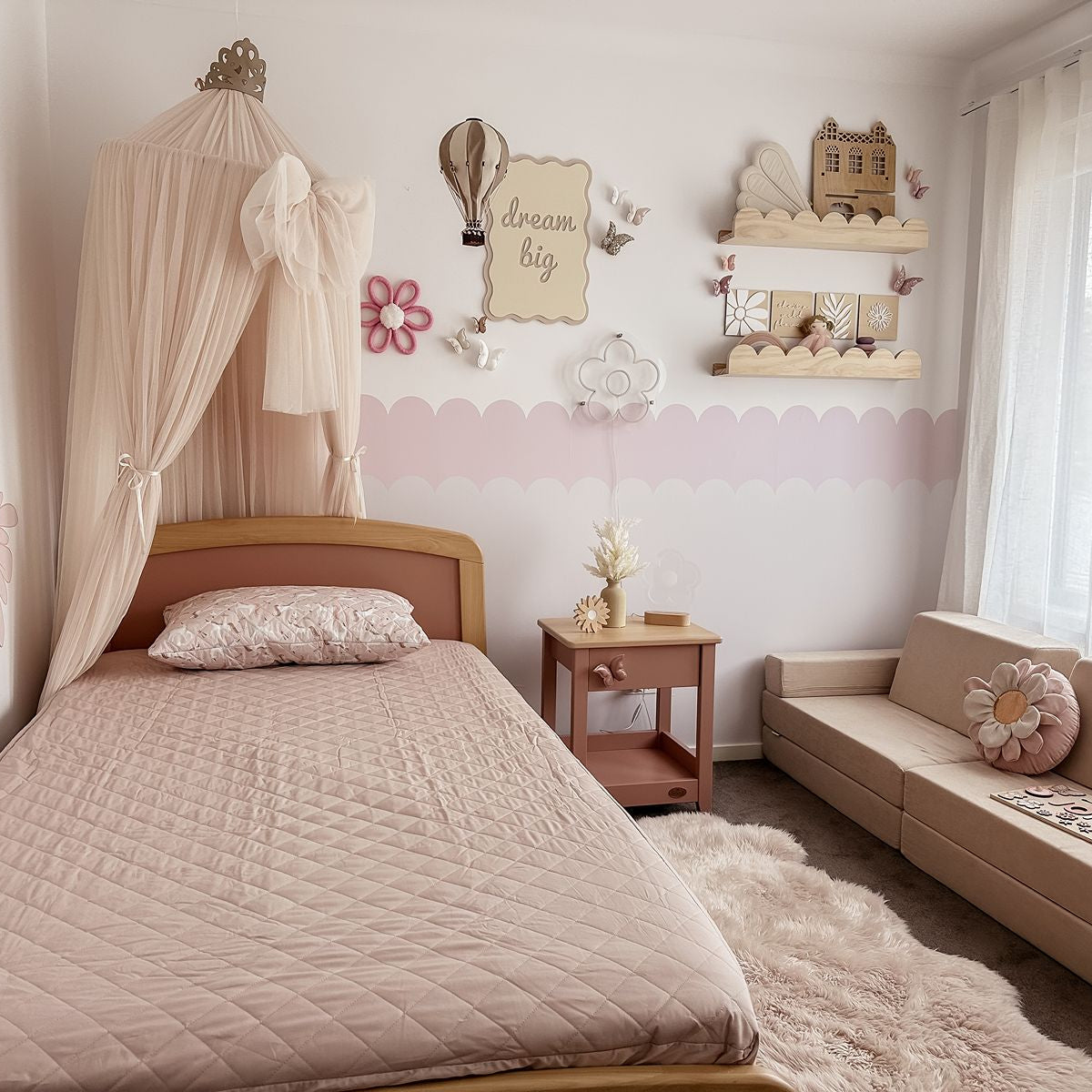 Children's bedroom with a bed, sofa, and decorative elements.